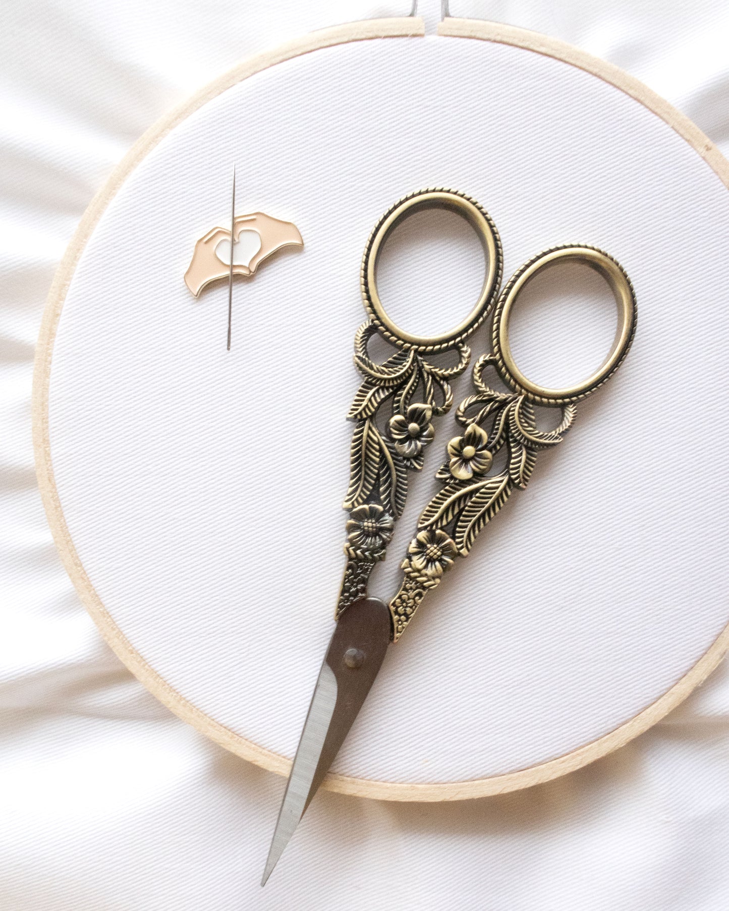 Vintage Floral Embroidery Scissors on an embroidery hoop with a needle minder