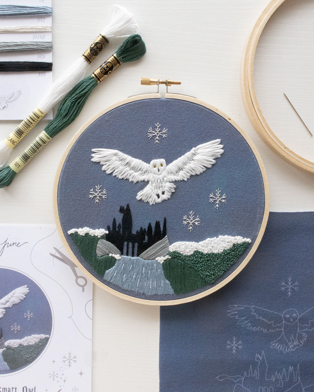 Magical Owl Embroidery Kit contents laid out with the finished piece in the middle