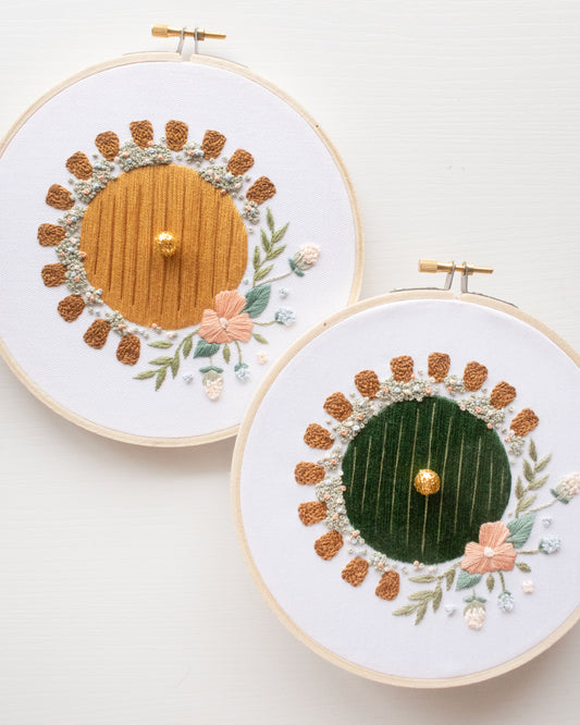 Hobbit Hole Embroidery Kit both versions showing green and yellow door