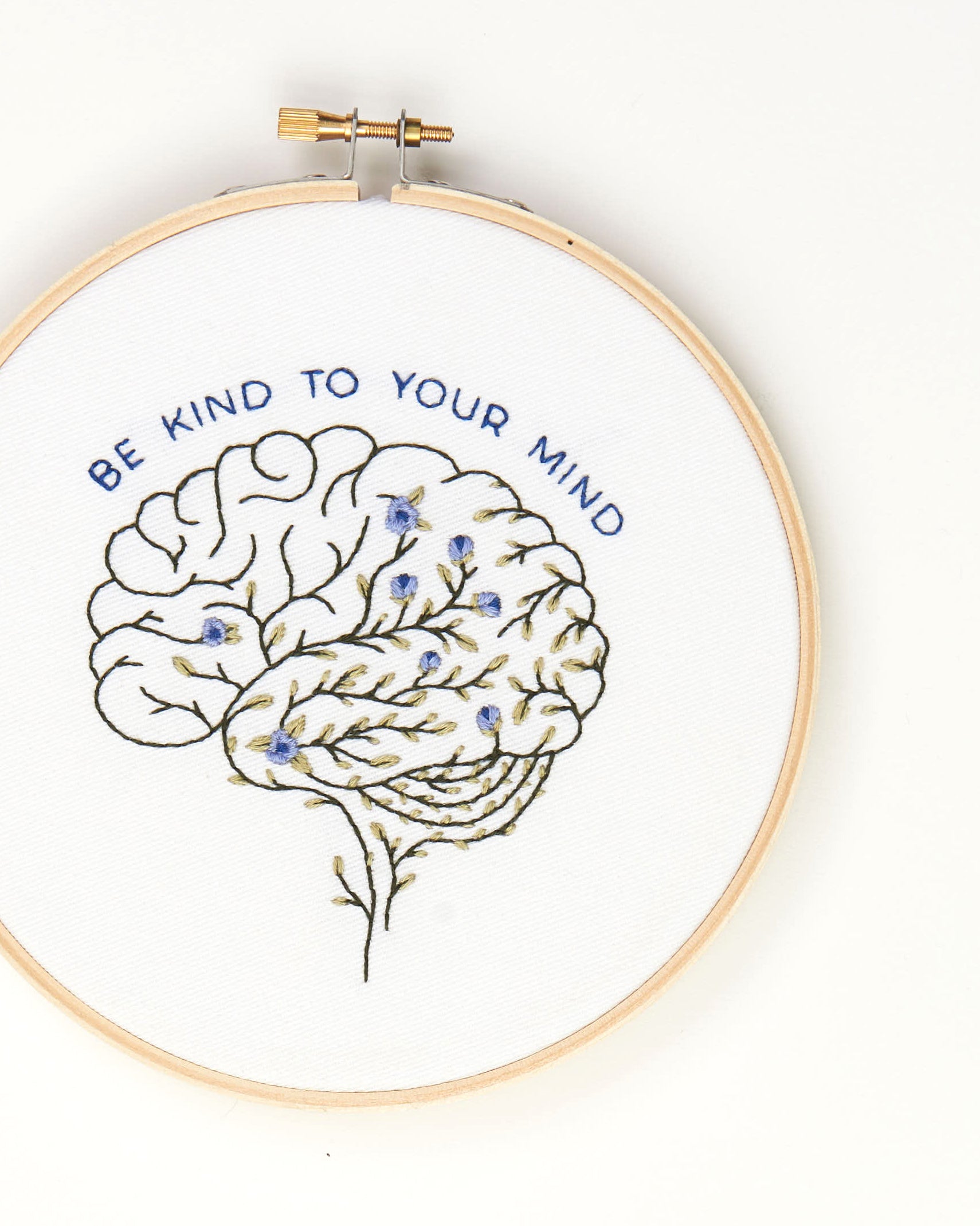 Be Kind To Your Mind Floral Brain Embroidery Kit finished on white background