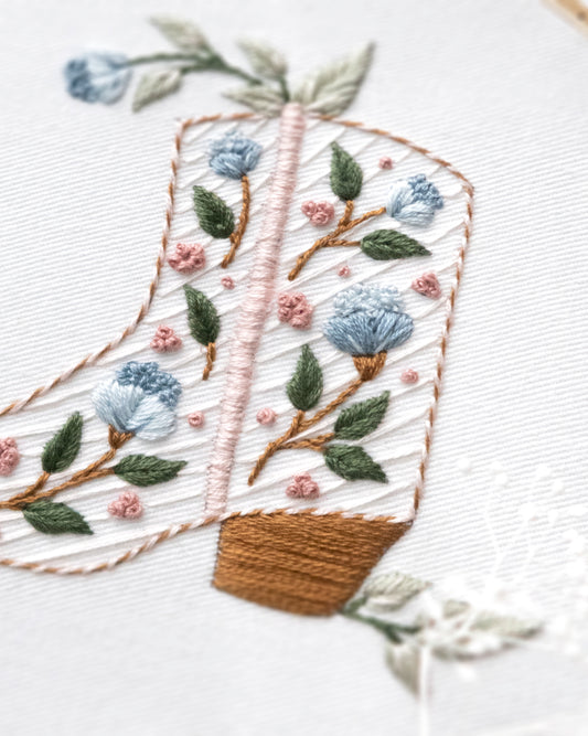 Floral cowboy boot hand embroidery pattern with pink and blue flowers and light green leaves