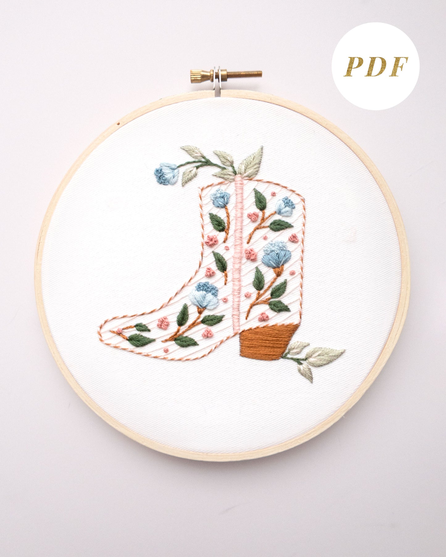 Floral cowboy boot hand embroidery pattern with pink and blue flowers and light green leaves