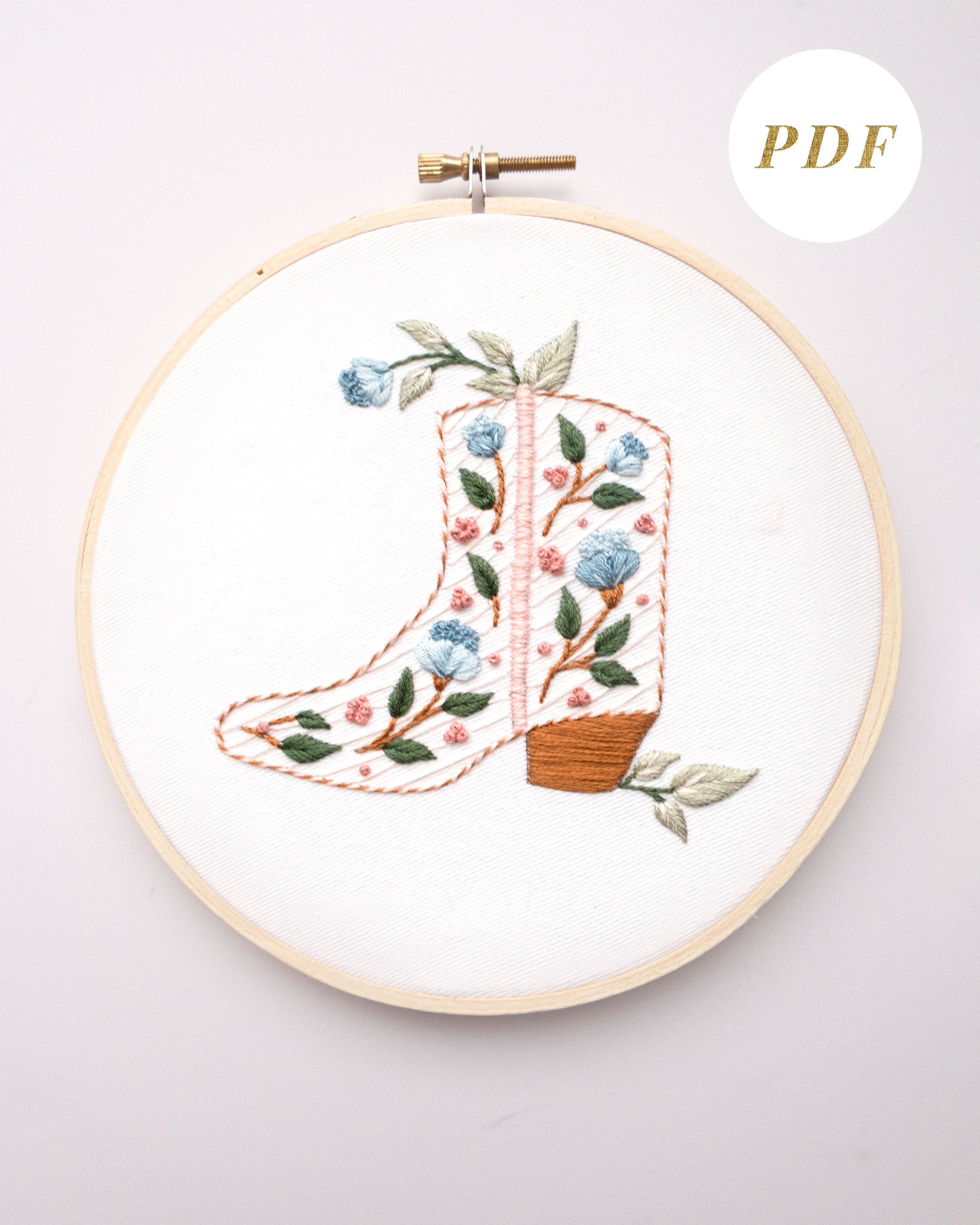 Floral cowboy boot hand embroidery pattern with pink and blue flowers and light green leaves