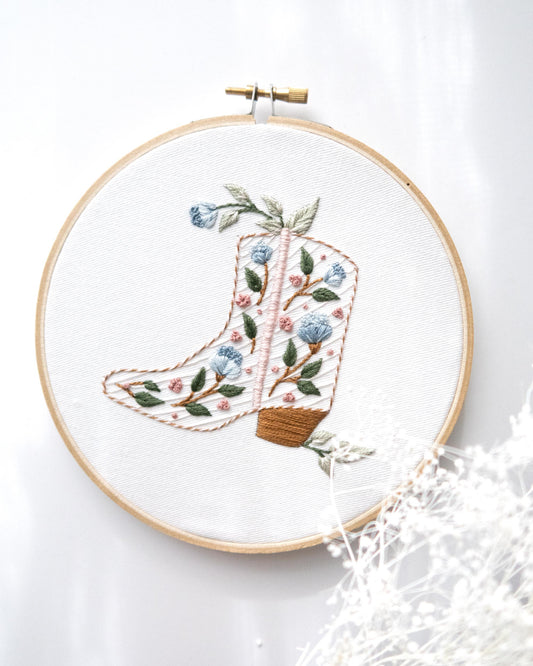 Floral cowboy boot hand embroidery kit with pink and blue flowers and light green leaves