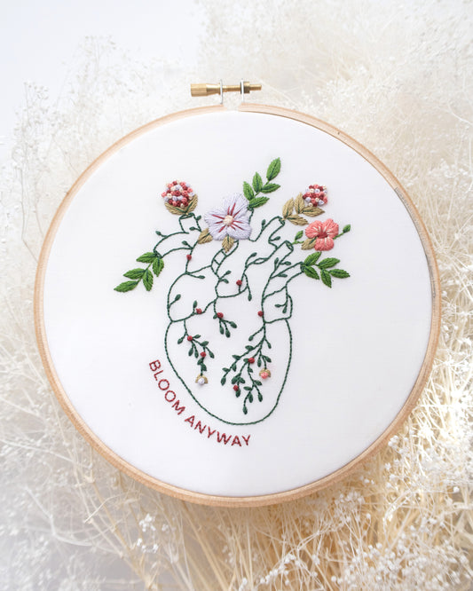 Bloom floral heart anatomy hand embroidery kit for mental health with pink, purple and red flowers and green leaves