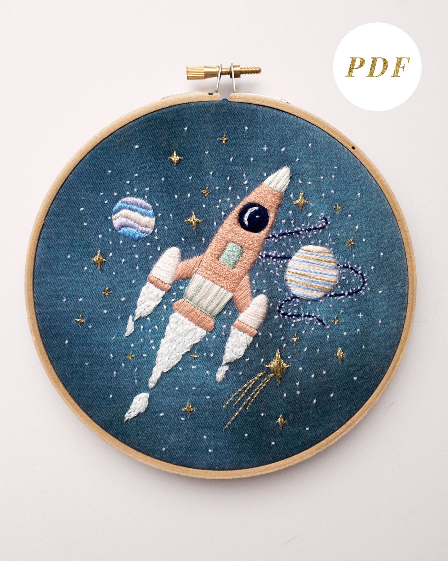 Pink rocket ship in outer space hand embroidery pattern for outer space nursery or decor with planets and stars