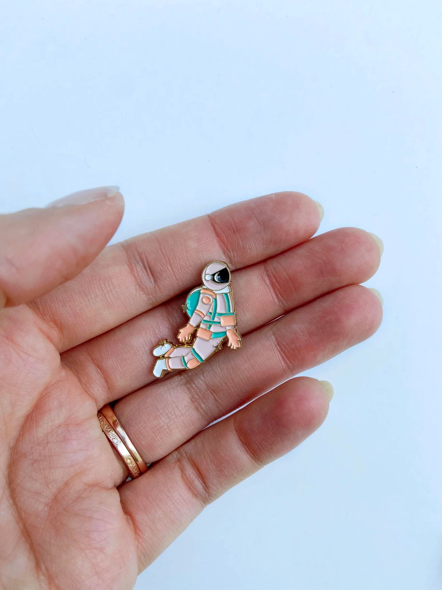 Pink and gold astronaut enamel needle minder or needle nanny with embroidery needle for hand embroidery hoop