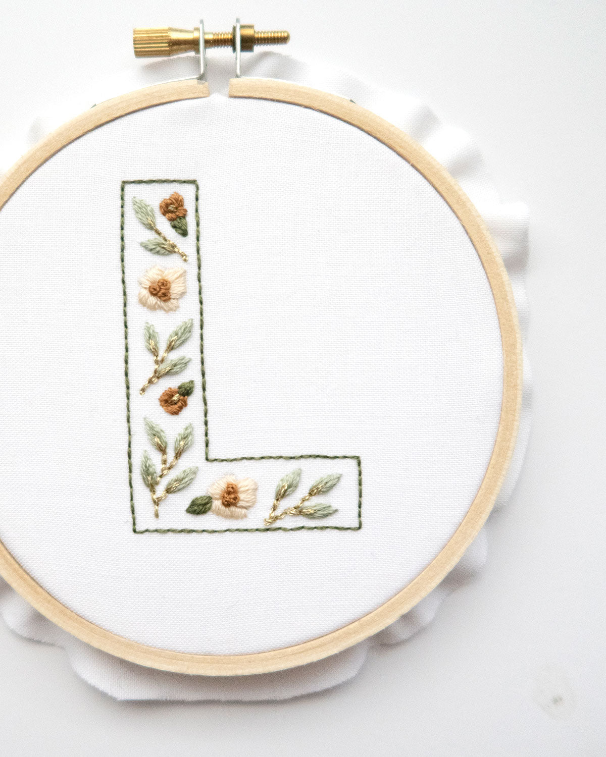 Floral Alphabet Embroidery Digital Pattern close up "L" on a white background