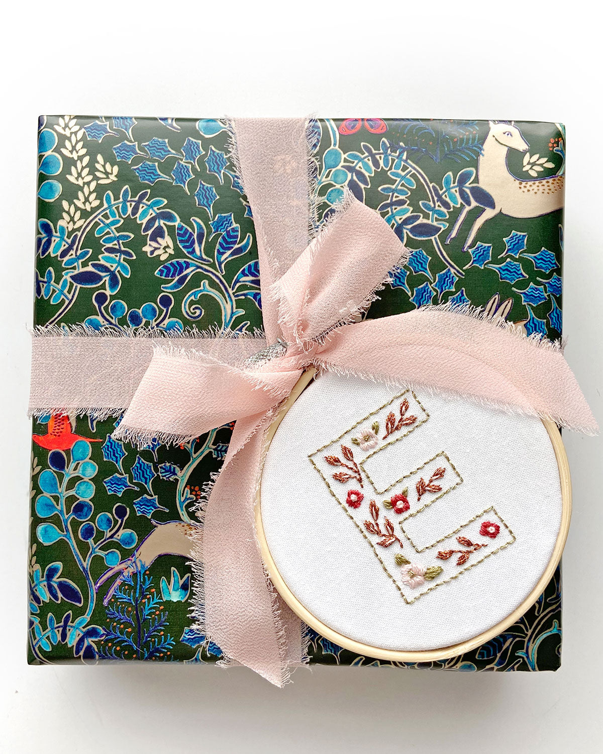 Floral Alphabet Embroidery Digital Pattern wrapped onto a present