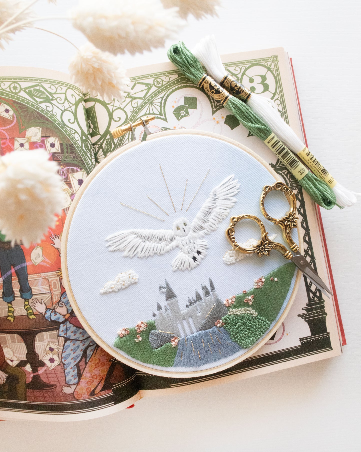 Spring Magical Owl Embroidery Kit on an open book with embroidery thread and floral scissors