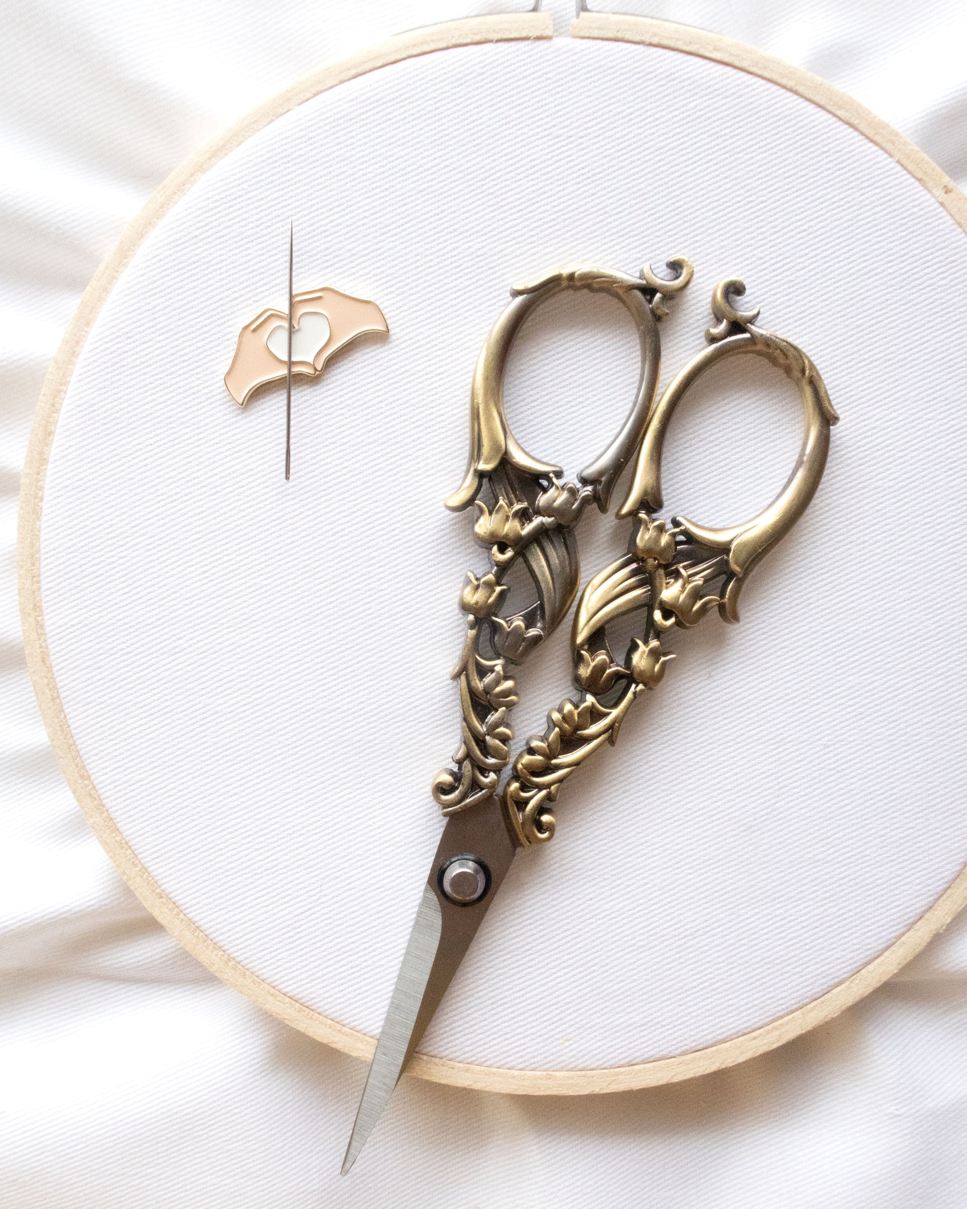 Vintage Tulip Embroidery Scissors on an embroidery hoop with a needle minder