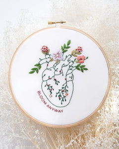 Bloom floral heart anatomy hand embroidery kit for mental health with pink, purple and red flowers and green leaves