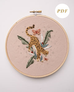 Cheetah in jungle hand embroidery pattern on light pink fabric, green jungle leaves, pink butterflies and silver stars
