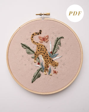 Cheetah in jungle hand embroidery pattern on light pink fabric, green jungle leaves, pink butterflies and silver stars