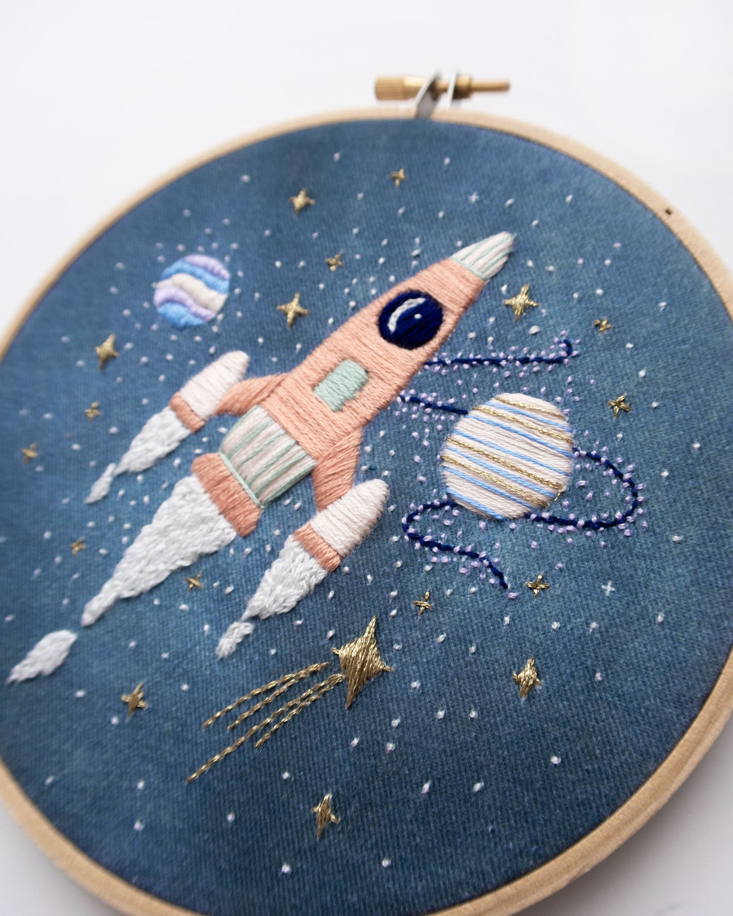 Pink rocket ship in outer space hand embroidery pattern for outer space nursery or decor with planets and stars