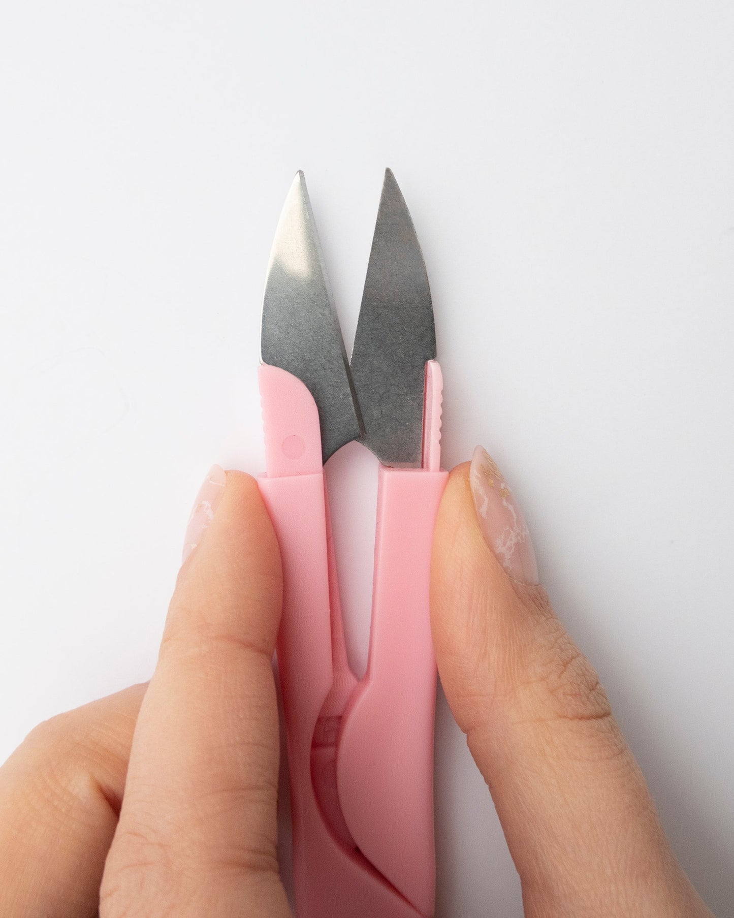 Close up of pink embroidery scissors or embroidery snips