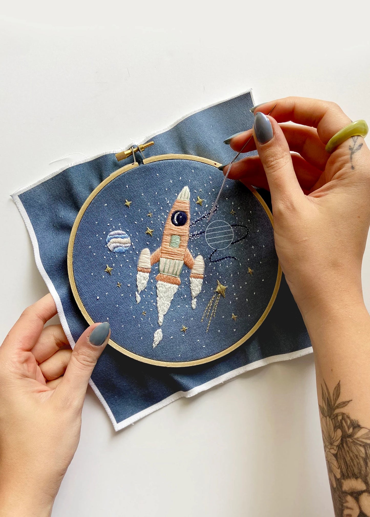 Pink rocket ship in outer space hand embroidery pattern for outer space nursery or decor with planets and stars